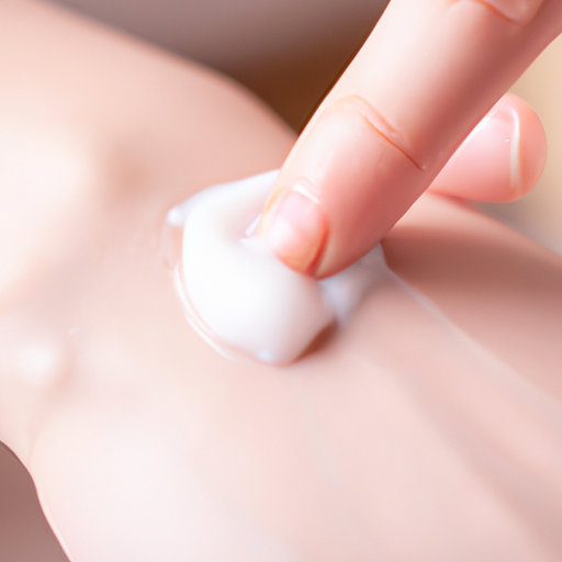 A close-up of a hand applying moisturizer to the skin